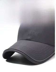 Detailed embroidery of letters on a dark grey breathable baseball cap with reinforced brim