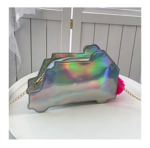 Detail of laser iridescent car-shaped crossbody bag with pink pompom and gold chain