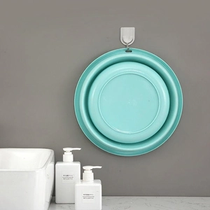 Wall-mounted foldable mint green basin for space-saving bathroom storage and home use