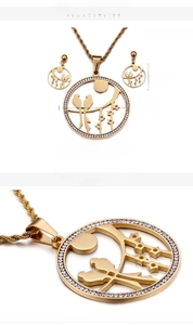 Close-up of golden bird earrings and necklace set with sparkling crystal accents