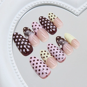 French style floral polka dot press-on nails with rhinestones on a white heart tray