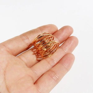 Creative multi-layer spiral spring wide ring in gold finish held in a palm