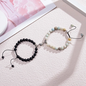 Detail of magnetic heart clasp on matte black and turquoise stone couple bracelets