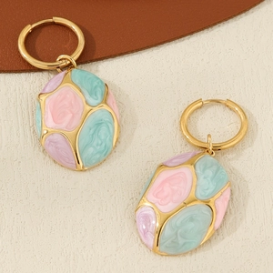 Close-up of gold-plated oval enamel drop earrings in pink, teal, and purple hues
