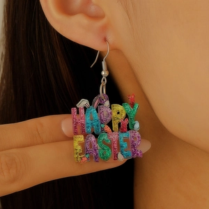 Macro detail of colorful acrylic Happy Easter earrings with glitter and bunny ear elements