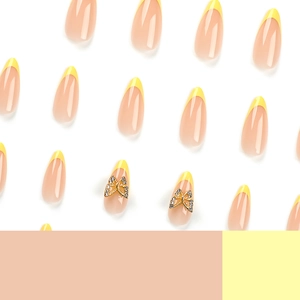 French almond fake nails with yellow tips and golden butterfly rhinestones accents