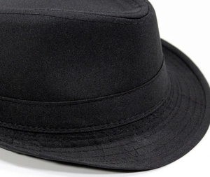 Detail of black panama hat showing fabric band and reinforced stitching on the brim