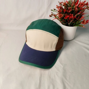 Detailed view of a vintage five-panel camper cap with a retro multi-color canvas design
