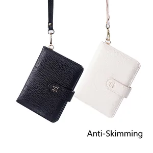 Portable RFID passport holder with lanyard and gold airplane motif in black and white