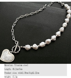 Detailed close-up of a silver titanium steel heart pendant necklace with pearl chain