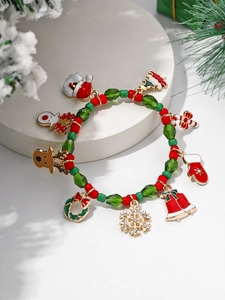 Detailed view of Christmas beaded bracelet with festive charms on a decorative stand