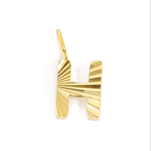 Close-up of a gold stainless steel letter H pendant with unique sunburst texture details