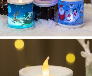 Close-up of LED Christmas candles with Santa and reindeer patterns in a snowy setting