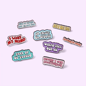 Set of eight colorful enamel pins with inspirational phrases for bags and accessories