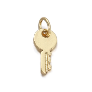 Macro shot of 18K gold-plated key pendant featuring a polished metallic finish and ring