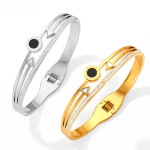 Detail view of double stainless steel bangles with Roman numerals and sparkling crystals
