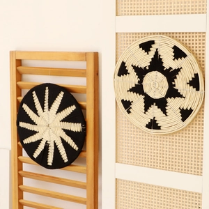 Nordic rattan wall hanging with black and white radial geometric patterns for home decor