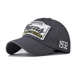 Close-up of charcoal gray baseball cap with Texas patch and 1932 side embroidery