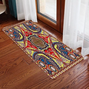Detail of bohemian runner rug with colorful ethnic patterns on dark wooden floor