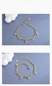 Detail of S925 sterling silver double-layer bracelet with sparkling clover pendants