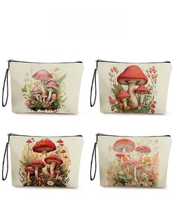 Detail showing four mushroom botanical prints on cream canvas makeup bags with wristlets
