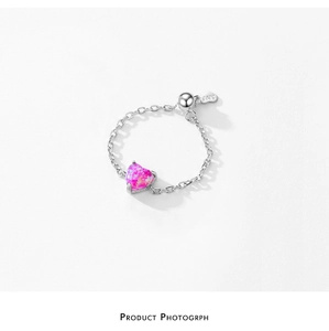 Macro shot of S925 sterling silver chain ring with heart-shaped pink opal gemstone