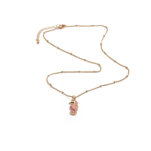 Golden seahorse pendant necklace with pink enamel details on a minimalist link chain