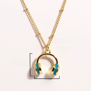 Detail view of gold headphone necklace with blue enamel showing 16x15mm dimensions and 5g weight