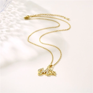 Gold-plated S925 silver MOM pendant necklace with sparkling cubic zirconia on white background