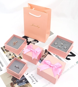 Pink jewelry gift boxes and paper bags with bows for necklaces, rings and earrings