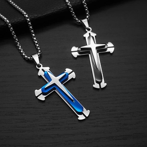 Macro detail of blue and black split triple cross pendants on stainless steel chains