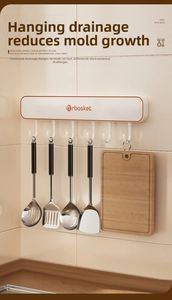 Detail of white kitchen rack with 6 hooks holding stainless steel utensils and a cutting board