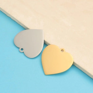Macro detail of 33mm heart-shaped mirror stainless steel pendants in gold and silver