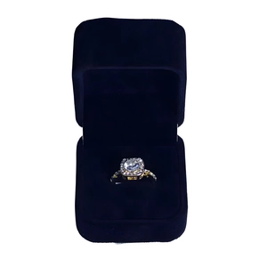 Detailed view of square halo engagement ring inside a deep blue velvet jewelry gift box