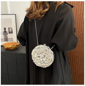 Detailed view of silver rose shaped jelly bag with metallic finish on black coat