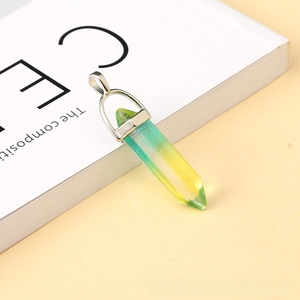 Macro detail of hexagonal crystal pendant with yellow-green gradient and silver clasp