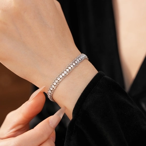 Close-up of sparkling three-row crystal woven chain bracelet on model wrist