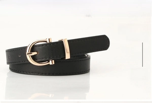Detail of black leather belt for women featuring a gold U-shaped metal buckle and stitching