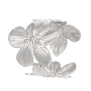 Macro view of silver flower ring with adjustable open band and wrinkled metal texture