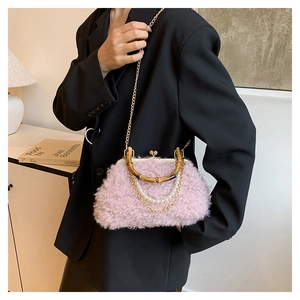 Detail of pink faux fur shell bag with bamboo handle and elegant pearl chain link