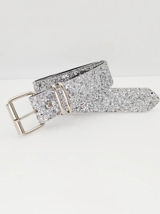 Detail of silver glitter belt with metallic buckle and sparkling Y2K texture