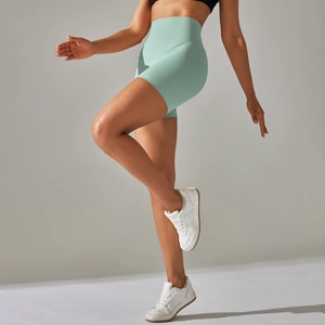 Detail of high-waist sage green yoga shorts with high-stretch peach-lift sculpting fit