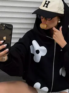 Oversized black zip-up hoodie featuring white floral prints and thick autumn fabric
