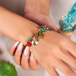Detail of hand-woven Christmas bracelet with festive tree, wreath charms and colorful beads