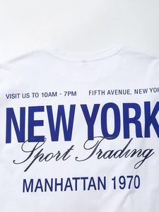 Detail of white cotton T-shirt featuring blue New York Sport Trading graphic print