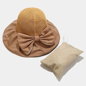 Detail of the sun hat showing bow decoration and the matching portable storage bag