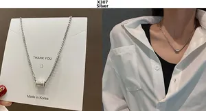 Detailed view of silver X307 hip-hop style necklace with engraved cylinder pendant