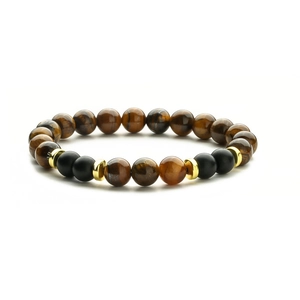8mm tiger eye and matte black beaded bracelet with gold spacers on white background