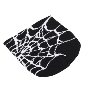 Detailed knit texture of black beanie with white spider web jacquard pattern