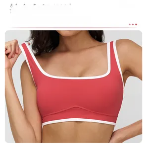 Detail of red sports bra with white contrast piping and square neckline stitching